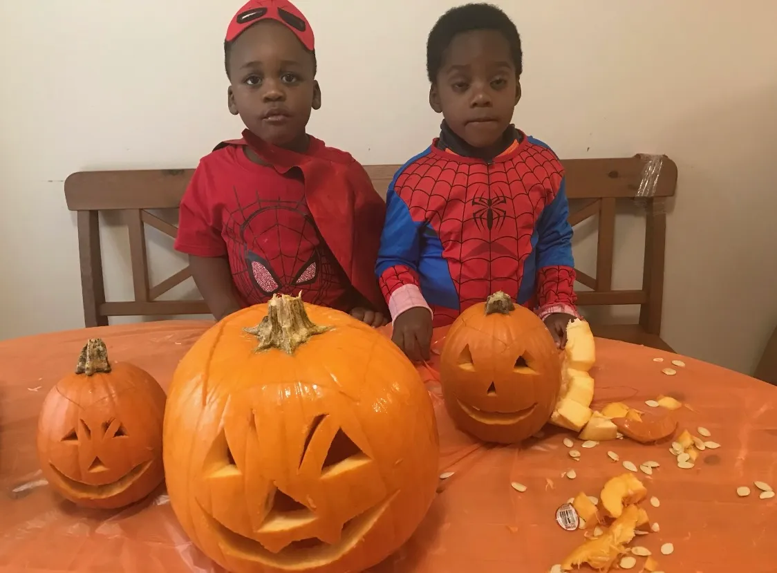Photo of daycare kids carving pumpkins